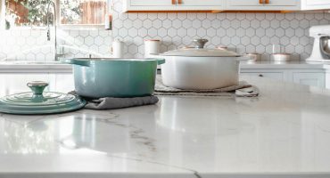 Close-up of quartz kitchen countertop with cookware in modern Florida home