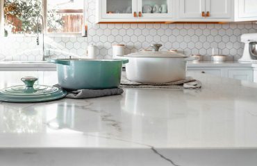 Close-up of quartz kitchen countertop with cookware in modern Florida home