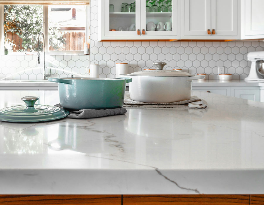Close-up of quartz kitchen countertop with cookware in modern Florida home